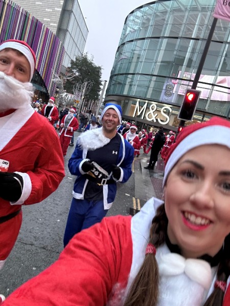 Children in care team do the Liverpool Santa Dash in red and blue santa suits for charity