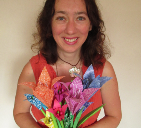 Lizzie Origami Pulse Mindful Origami Sessions pictured with a bunch of origami flowers