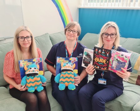 Female staff holding fundraising items